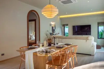 Elegant living room with modern dining area and stylish lighting, perfect for entertaining guests.