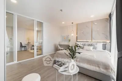 Luxurious modern bedroom with elegant decor and spacious layout, featuring a stylish vanity and cozy ambiance.