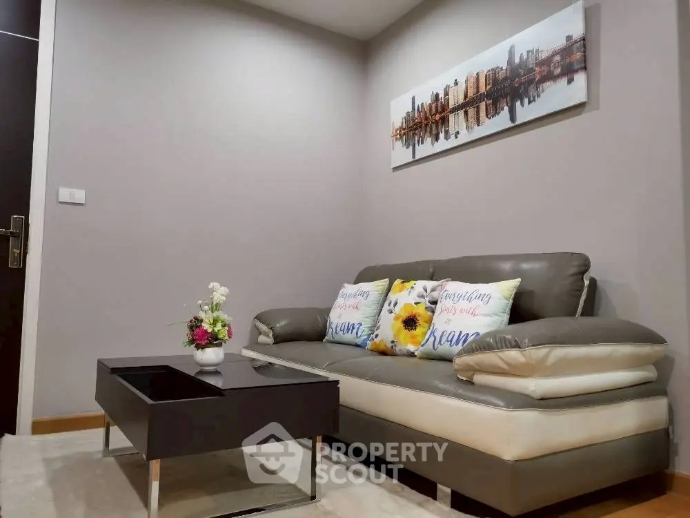 Modern living room with stylish sofa and cityscape artwork, perfect for urban living.
