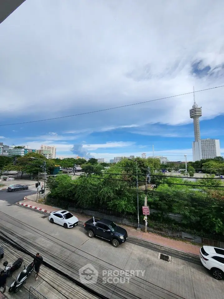 Stunning cityscape view from a high-rise balcony with clear skies and urban landscape.
