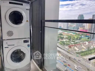 Modern high-rise balcony with city view and stacked washer dryer unit.