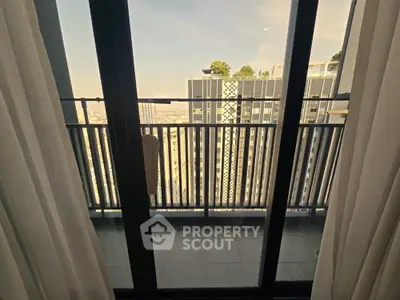 Modern high-rise balcony view with cityscape and glass doors