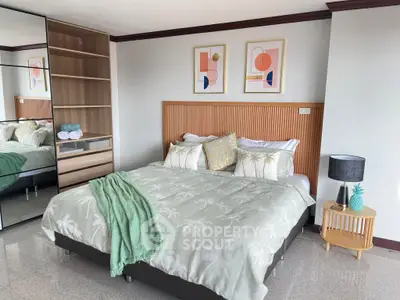 Stylish bedroom with modern decor and mirrored closet doors