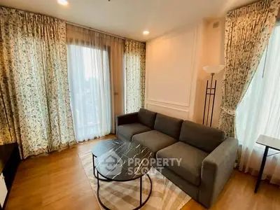 Charming living room with elegant curtains and cozy sofa in modern apartment