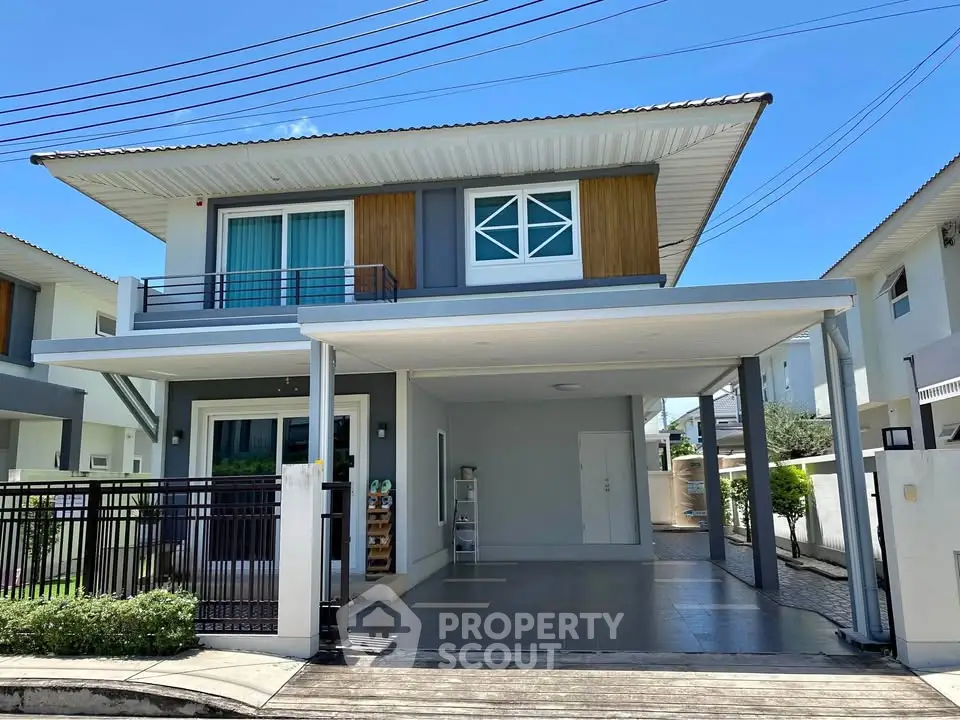 Modern two-story house with carport and stylish facade in sunny neighborhood.
