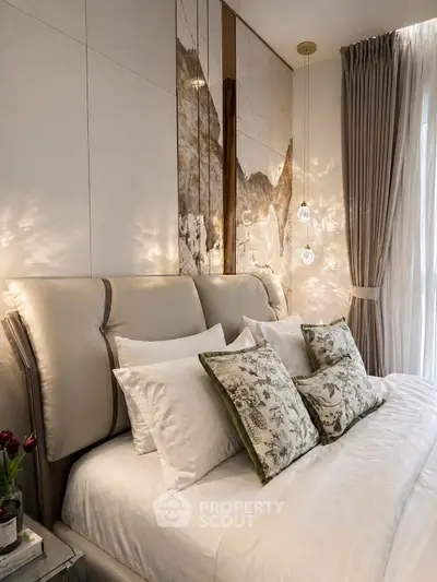 Luxurious bedroom with elegant decor and plush bedding, featuring stylish lighting and floor-to-ceiling curtains.