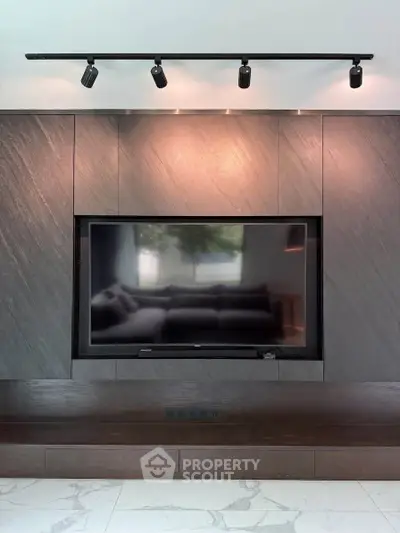 Modern living room with sleek TV setup and elegant lighting