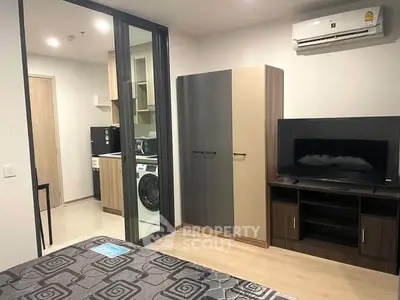 Modern studio apartment with sleek kitchen and cozy living area