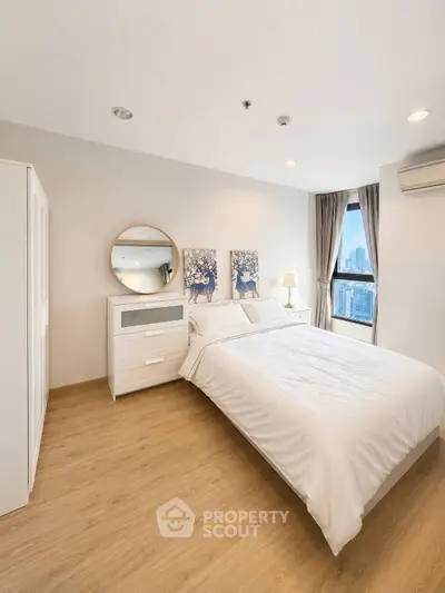 Modern bedroom with city view, featuring stylish decor and natural light.