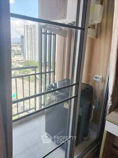 High-rise apartment balcony with city view and air conditioning unit.