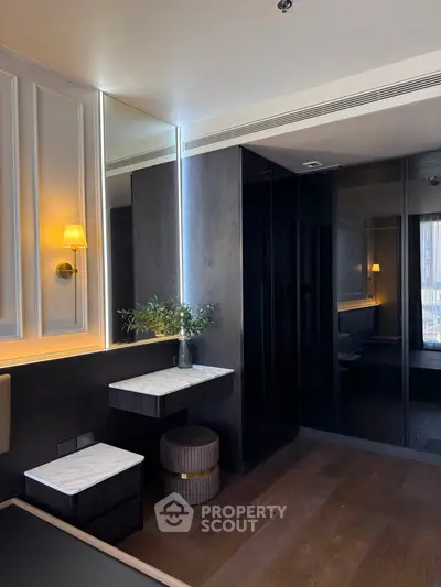 Luxurious modern bedroom with elegant lighting and sleek dark wood finishes.