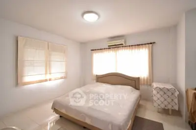 Cozy bedroom with natural light and air conditioning in modern home