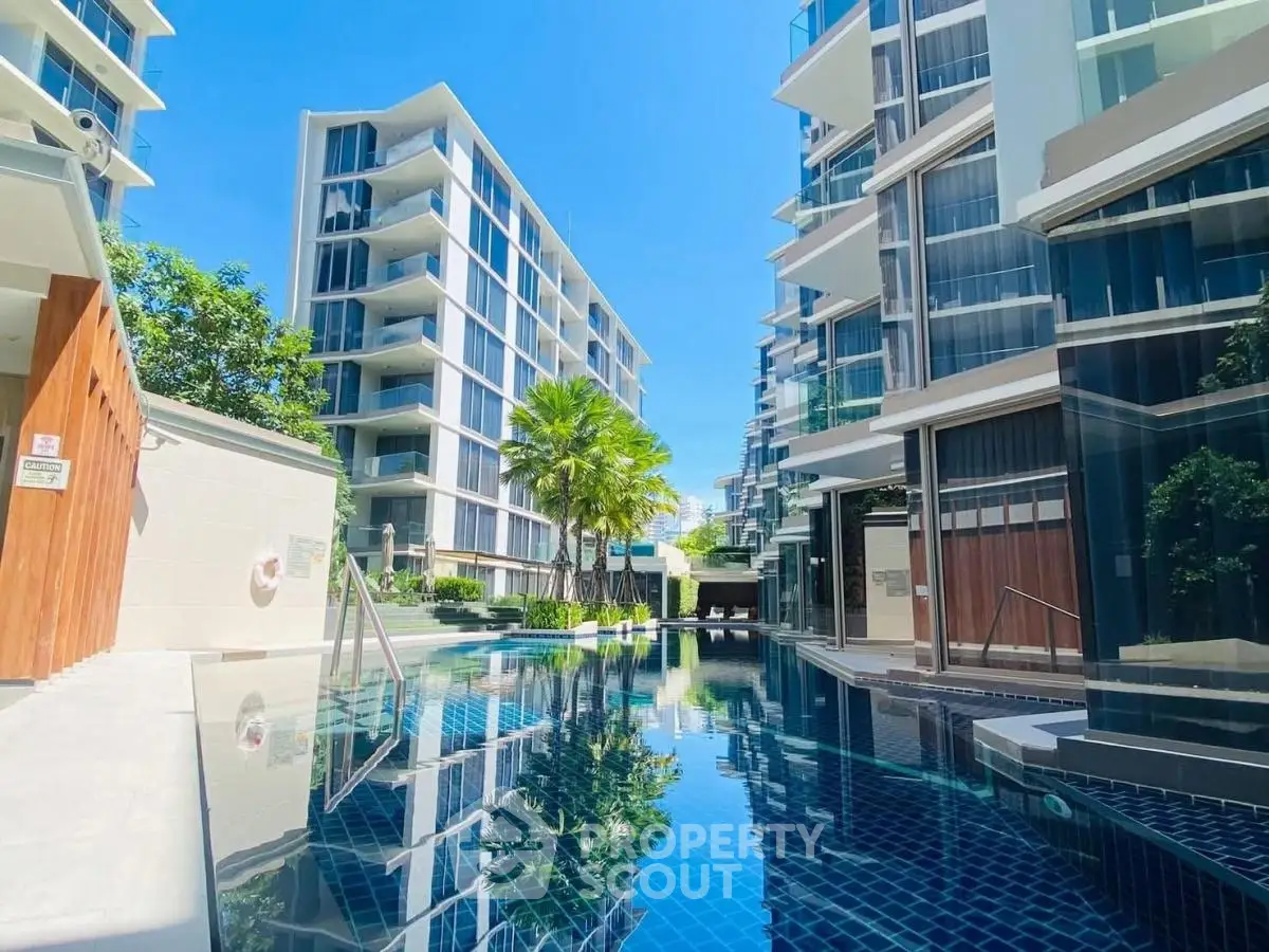 Luxurious modern condominium with stunning pool and lush greenery