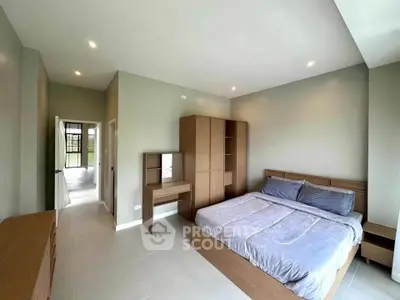 Spacious modern bedroom with sleek furniture and natural light