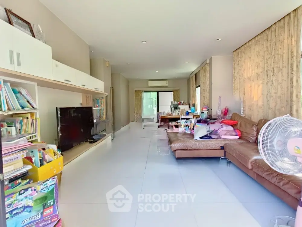 Spacious living room with modern decor and ample natural light