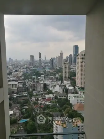 Stunning cityscape view from high-rise balcony showcasing urban skyline and greenery.