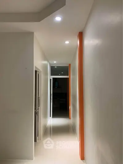 Modern hallway with recessed lighting and sleek design