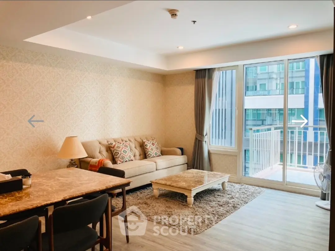 Spacious living room with elegant decor and large windows in modern apartment.