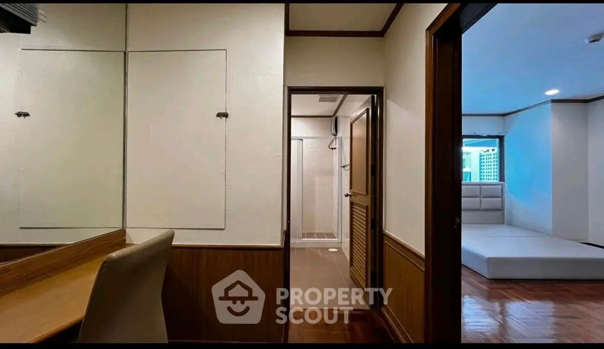 Cozy interior with study area and glimpse of bedroom, featuring wooden accents and modern design.