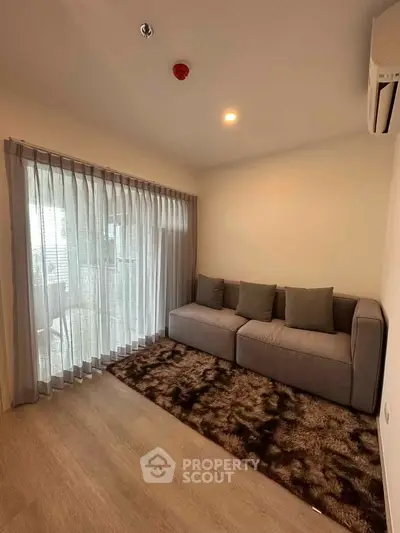 Cozy living room with modern sofa and large window for natural light