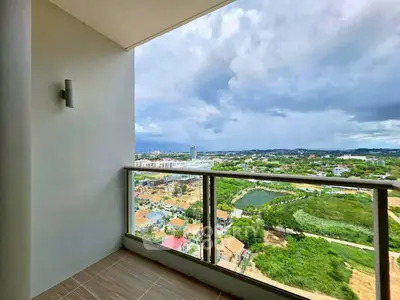 Stunning balcony view of lush landscape and cityscape from high-rise apartment