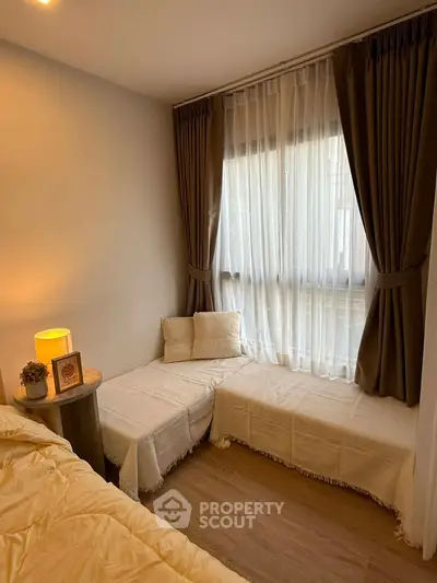 Cozy bedroom with elegant curtains and soft lighting, perfect for relaxation.