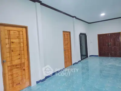 Spacious interior with wooden doors and blue tiled flooring