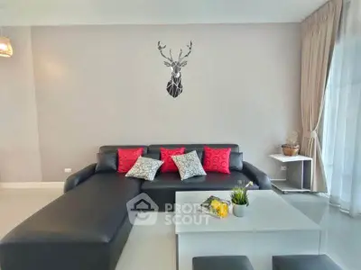 Modern living room with stylish black sofa and decorative wall art