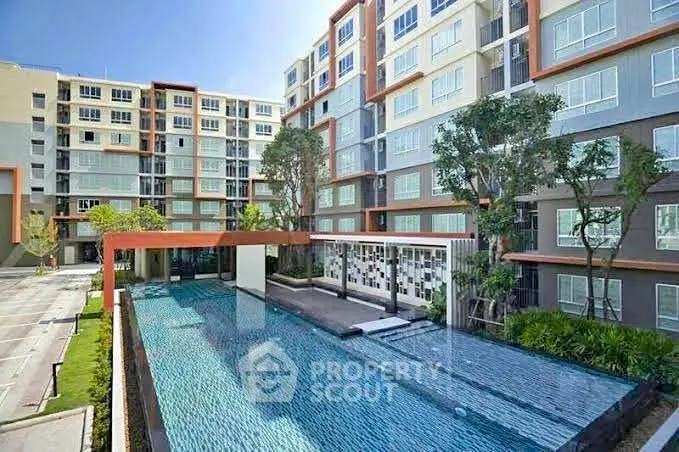 Modern apartment complex with a stylish outdoor pool and lush landscaping.