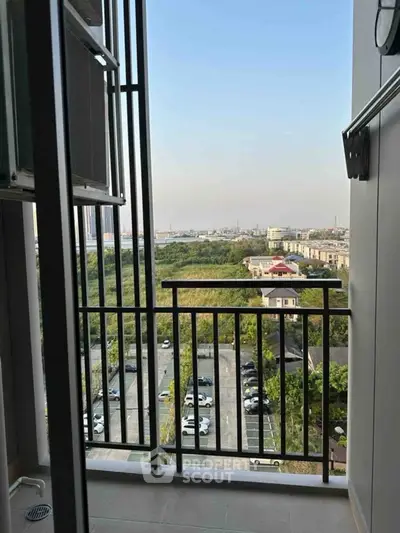 Stunning balcony view overlooking lush greenery and cityscape, perfect for relaxation and enjoying sunsets.