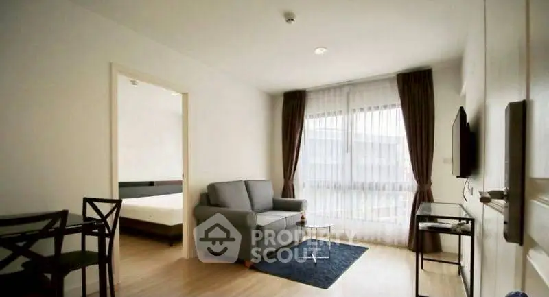 Modern living room with cozy sofa and large window in a stylish apartment.
