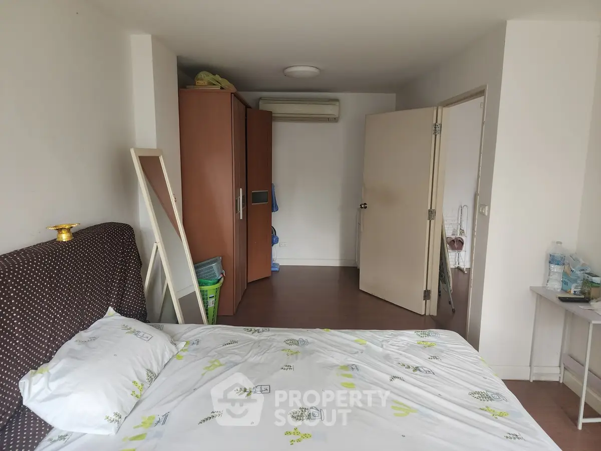 Cozy bedroom with modern decor and ample storage space, perfect for comfortable living.