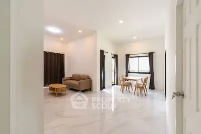 Spacious open-plan living and dining area with modern furnishings and natural light.