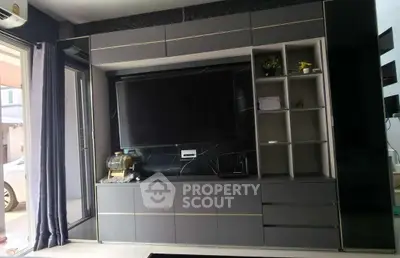 Modern living room with sleek entertainment center and large TV