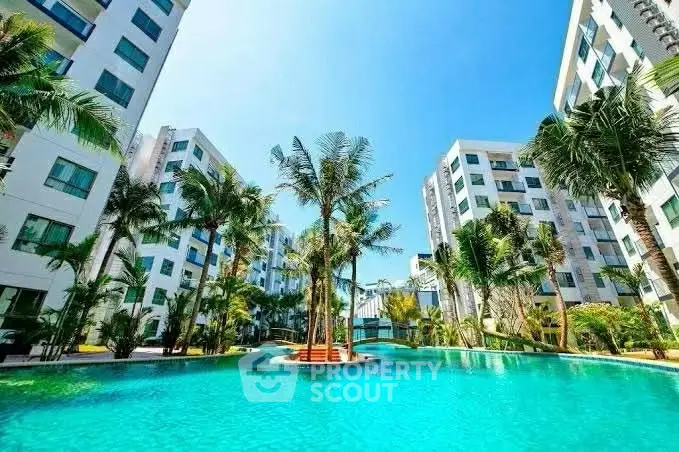Luxurious apartment complex with stunning pool and lush palm trees