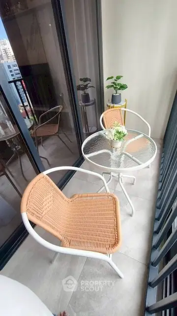 Charming balcony with modern furniture and city view, perfect for relaxation.