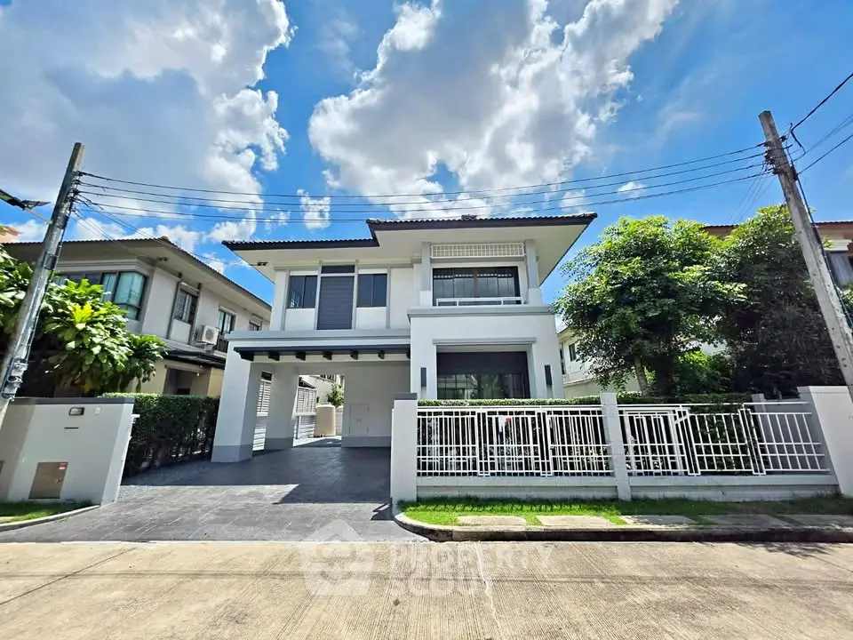 Stunning modern two-story house with sleek design and spacious driveway in a serene neighborhood.