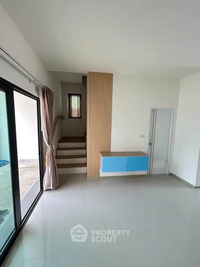 Modern interior with sleek staircase and large sliding glass doors