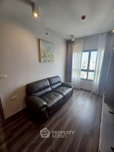 Modern living room with leather sofa and city view window