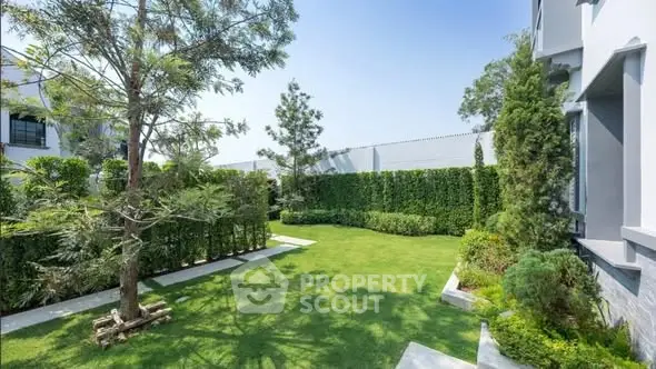 Beautifully landscaped garden with lush greenery and modern architecture, perfect for outdoor relaxation.