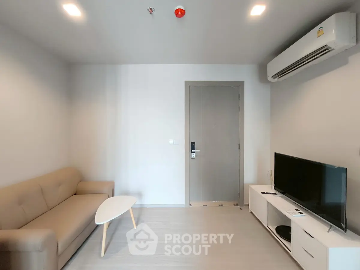 Modern living room with sleek furniture and air conditioning, perfect for cozy gatherings.