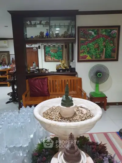 Charming living room with unique decor and indoor fountain, perfect for relaxation and style.
