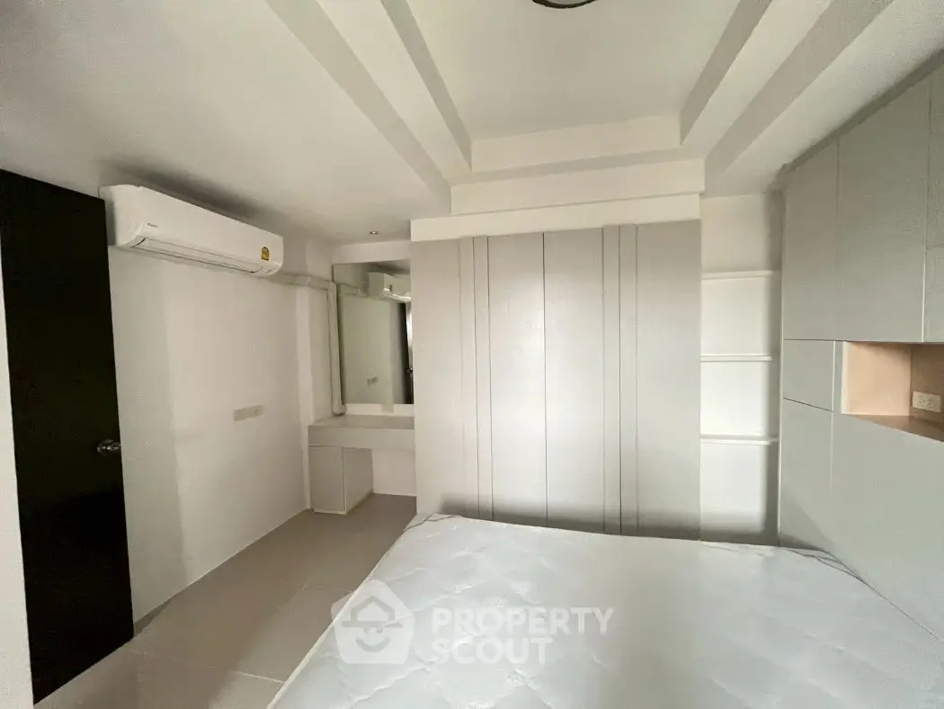 Modern bedroom with sleek design and built-in storage solutions