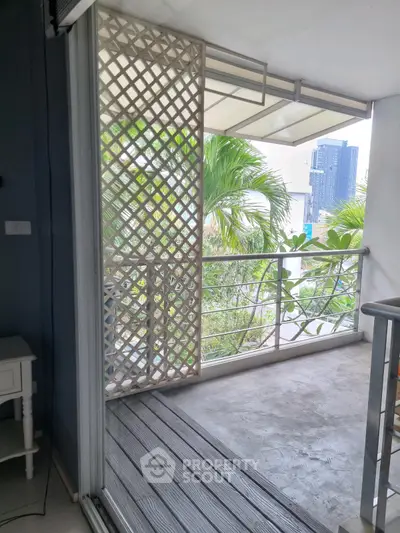 Charming balcony with lush greenery and modern railing, perfect for relaxation and enjoying the view.