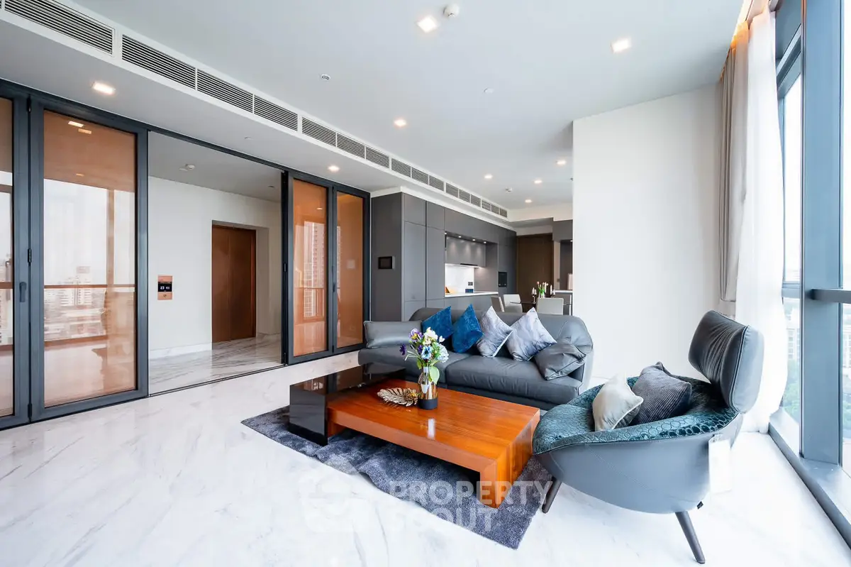 Luxurious modern living room with elegant furniture and open kitchen layout