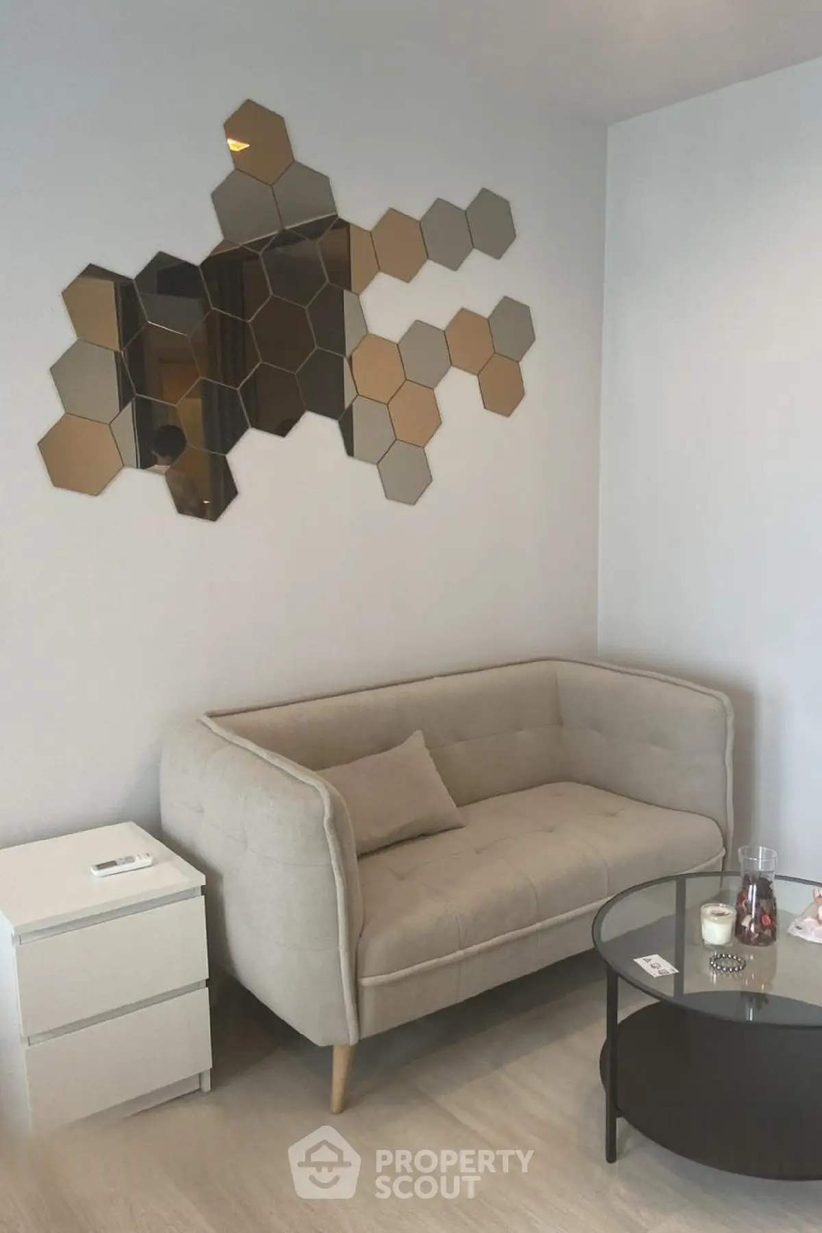 Stylish modern living room with hexagonal mirror decor and cozy beige sofa