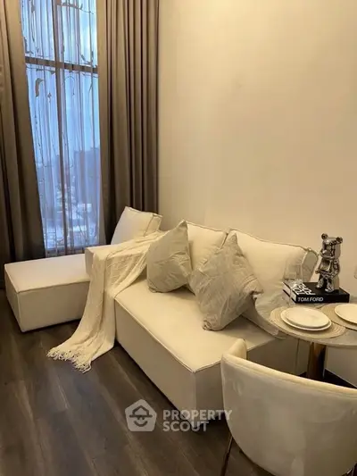 Elegant living room with modern decor and plush seating in a cozy apartment.
