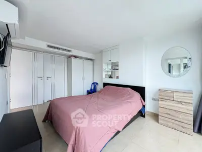 Spacious bedroom with modern decor and ample natural light