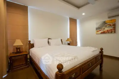 Spacious bedroom with elegant wooden furniture and cozy lighting