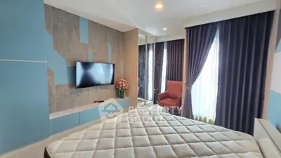 Modern bedroom with stylish decor, large window, and wall-mounted TV in a luxurious apartment.